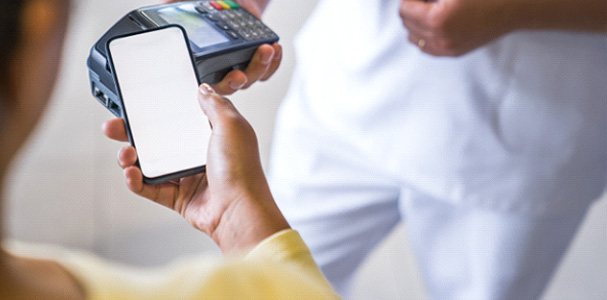 A patient using their phone to pay for a dental visit