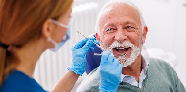 Man smiling at dentist during dental exam