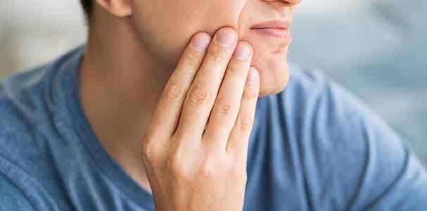 Close-up of man with discomfort in jaw